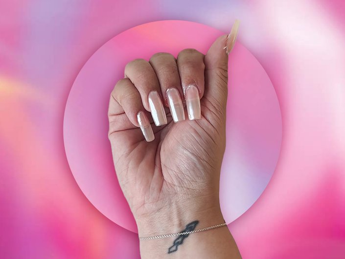 Picture of an editor with neutral chrome nails on a pink graphic gradient background
