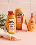 Image of Garnier Whole Blends Honey Treasures collection in a pink bathroom