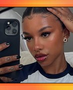 person taking a selfie in their mirror on red and orange graphic background