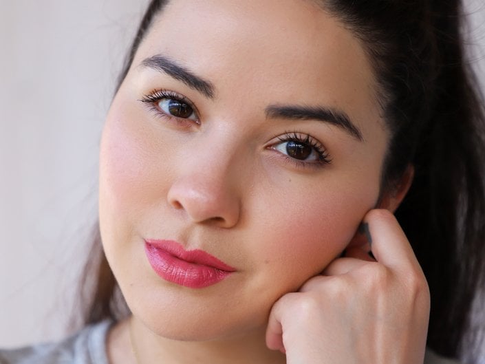 person wearing pink lipstick