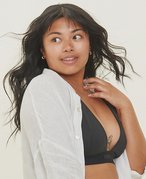 person touching their decolletage