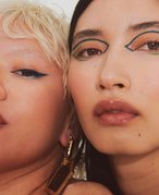 close-up photo of two models with graphic eyeliner looks