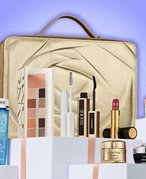 Lancôme Holiday Beauty Box with products out on display, collaged against a purple background