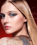 Image of three holiday gift sets on a graphic purple background