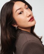 nyx matte lipsticks photographed on a bright pink prismatic background