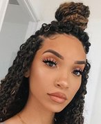Person with hair styled in passion twists in a half-up, half-down bun