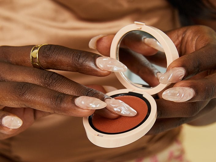 person dipping finger into Giorgio Armani Beauty Neo Nude Melting Color Balm blush compact