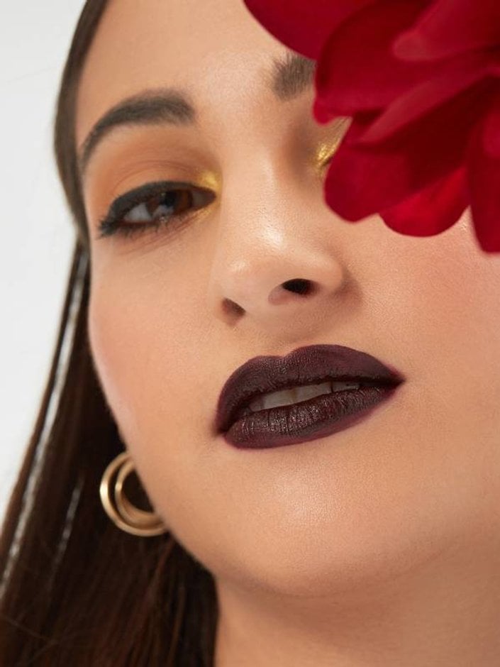 person with medium skin tone wearing dark lipstick