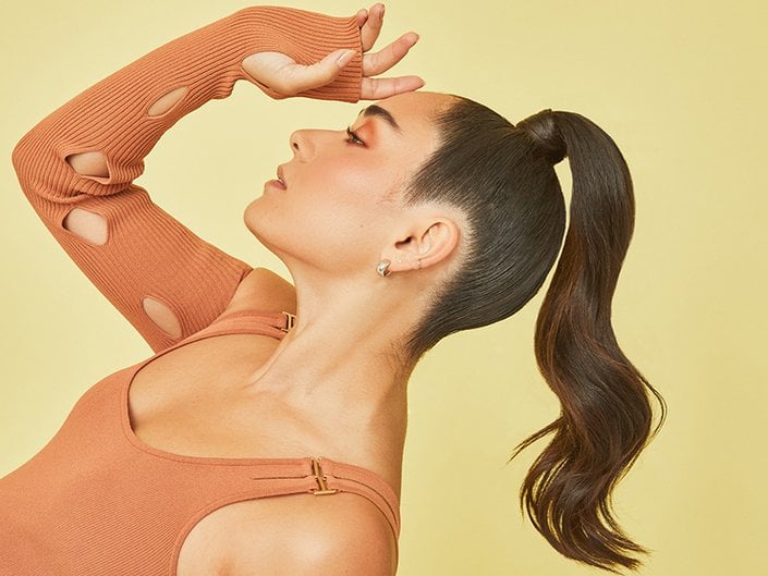 Picture of a model with a high ponytail leaning backwards