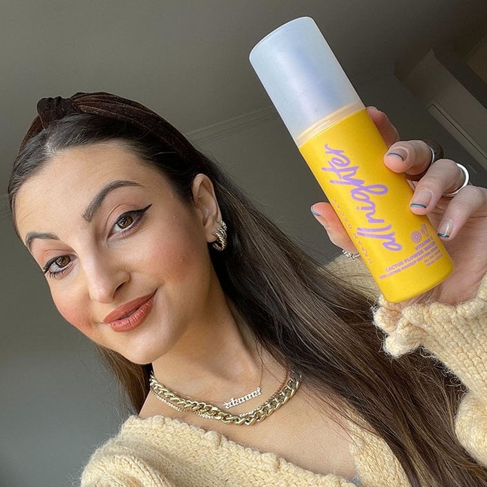 person holding setting spray