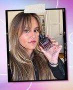 Purple and lavender gradient background with a picture of a person holding the Valentino Beauty Donna Born In Roma Intense Perfume.