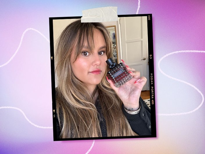 Purple and lavender gradient background with a picture of a person holding the Valentino Beauty Donna Born In Roma Intense Perfume.