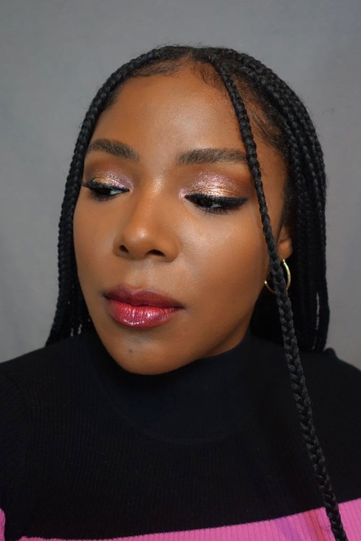 person wearing pink and gold glitter eyeshadow and red sparkly lipstick